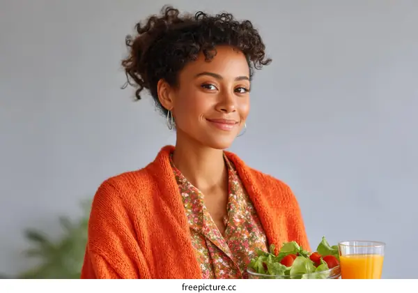 Smiling Woman with Salad and Orange Juice