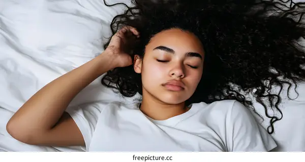 Young Woman Sleeping in Bed