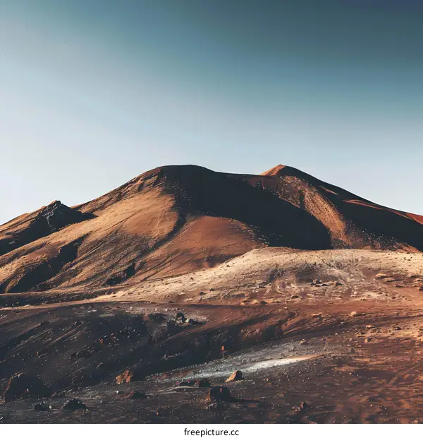 Red Volcanic Mountain Landscape Under Blue Sky