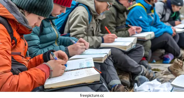 Students Writing in Notebooks During a Class Trip