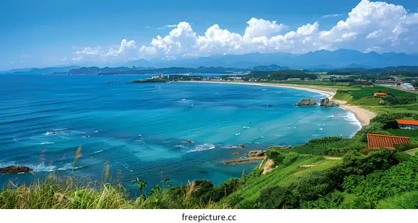 Aerial View of Coastline with Blue Ocean and Green Hills