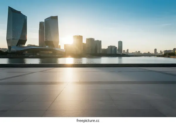 Sunset over modern city skyline with empty foreground