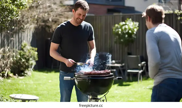 Man Grilling Meat in Backyard with Friend