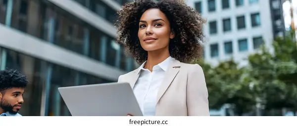 Successful Business Woman Walking Outside With Laptop