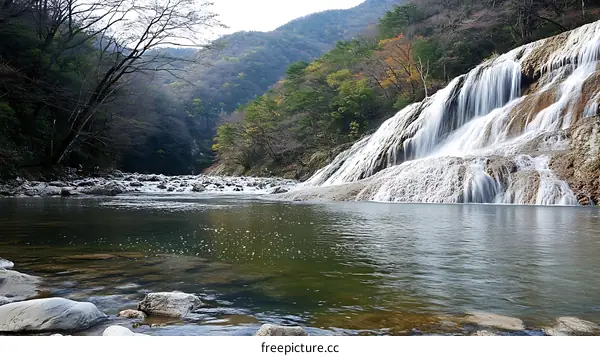 Majestic Waterfall Cascading into a Serene River