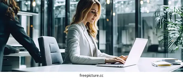 Woman Working on Laptop in Modern Office