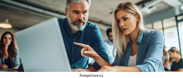 Business Colleagues Working Together on a Laptop in an Office