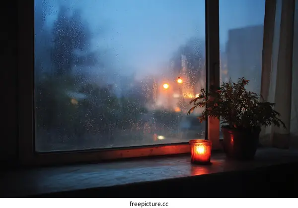 Rainy Night Window View with Candlelight