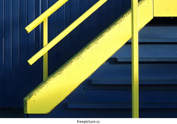 Yellow Handrail on Blue Stairs
