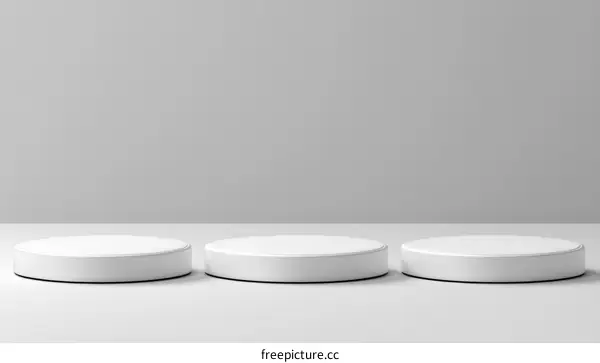 Three White Round Podiums on a Light Gray Background