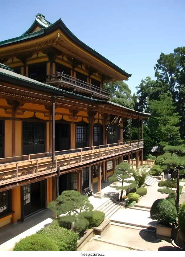 A photo of a Japanese temple with a long balcony and a garden