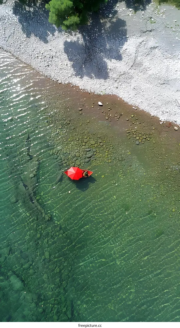 Aerial View of Red Boat on a Clear Lake