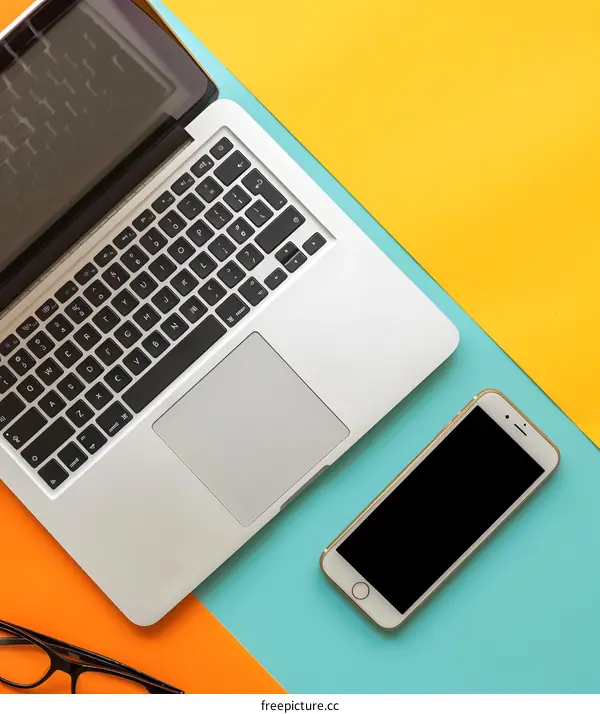 Laptop, Phone and Glasses on Colorful Background