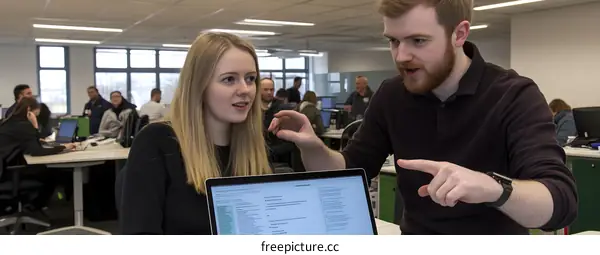 Two Colleagues Talking About Work in Office Setting