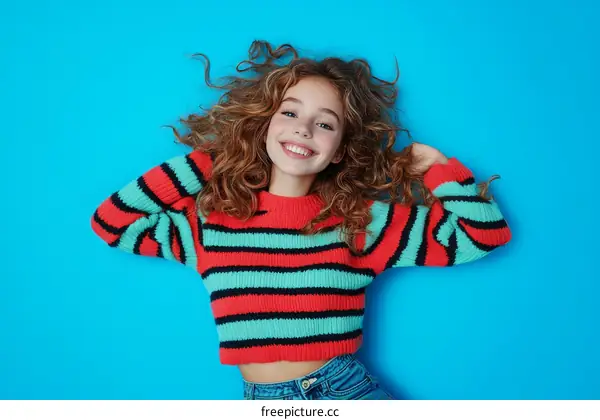 Smiling Girl in a Colorful Striped Sweater