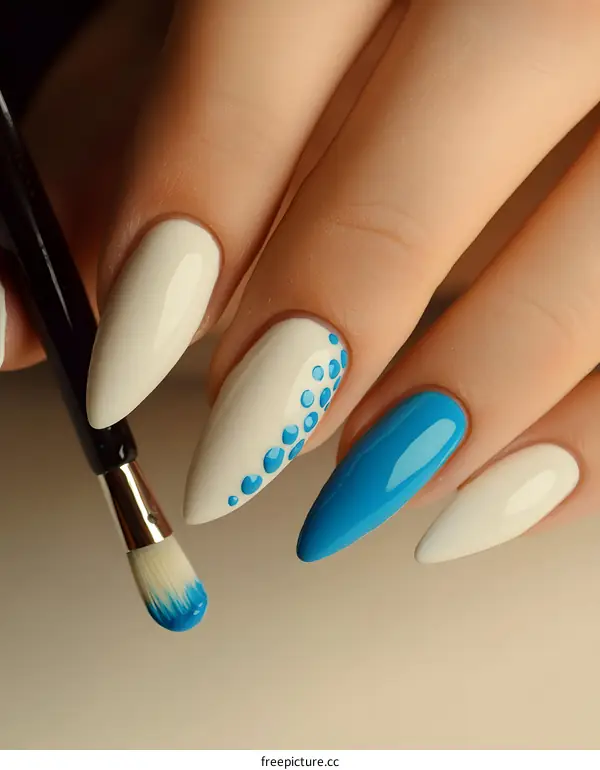 Close Up Of Woman Hands With White And Blue Nail Polish