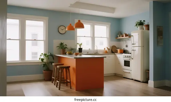 Modern blue kitchen with orange island and pendant lights