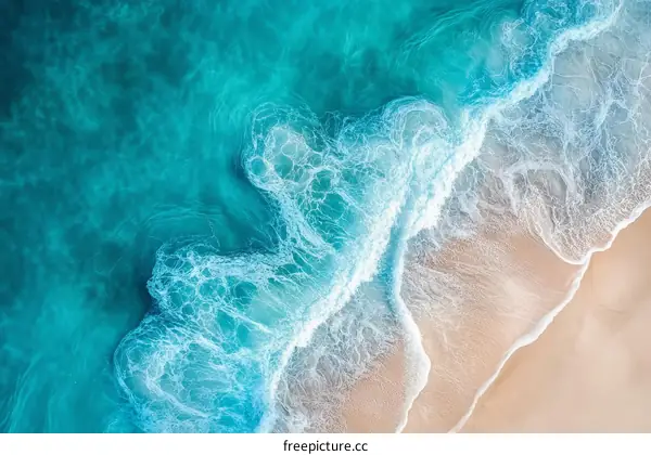 Aerial View of Turquoise Waves Crashing on a Sandy Beach