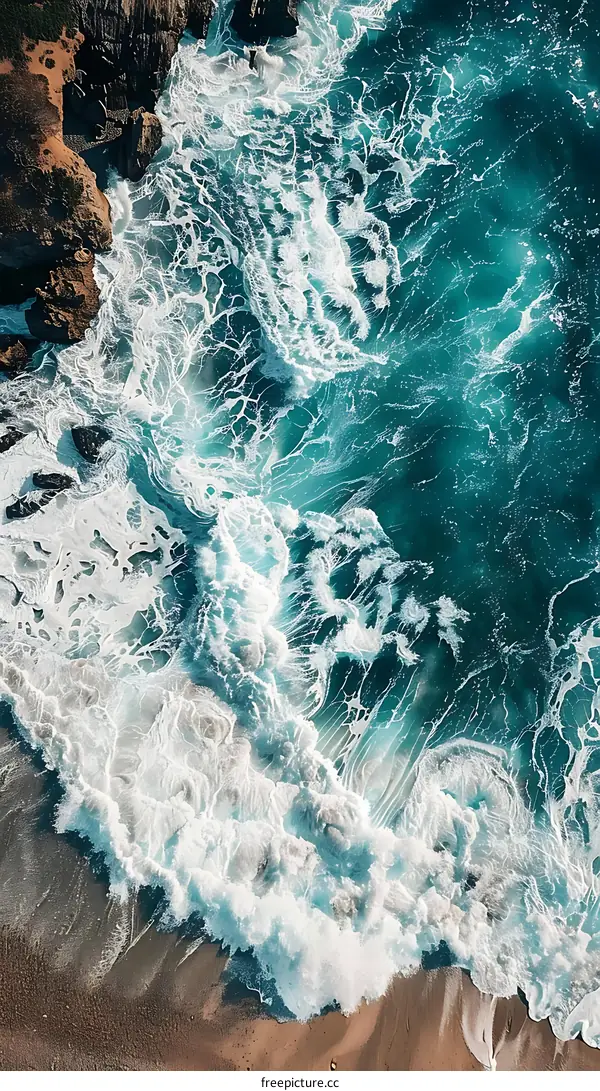 Aerial View of Ocean Waves Crashing on Sandy Shore