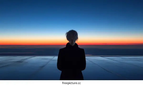 Woman Contemplating Sunrise over Clouds