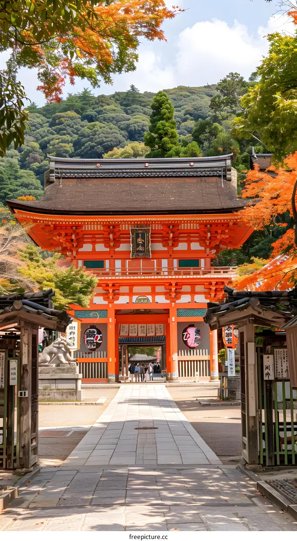 Traditional Japanese Gate with Red Pillars and Stone Path