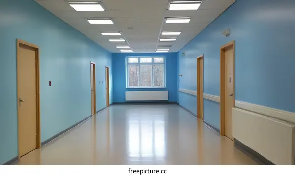 Empty Hospital Corridor with Light Blue Walls