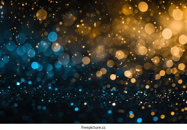 Blue and gold glitter background with shiny lights. Defocused blue and gold glitter lights.