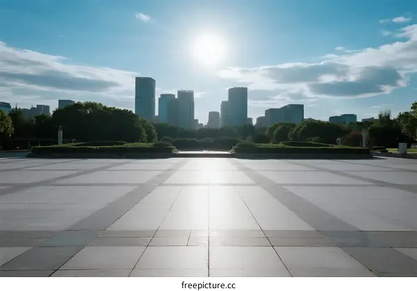 Sunny day view of urban square with modern skyscrapers in the background