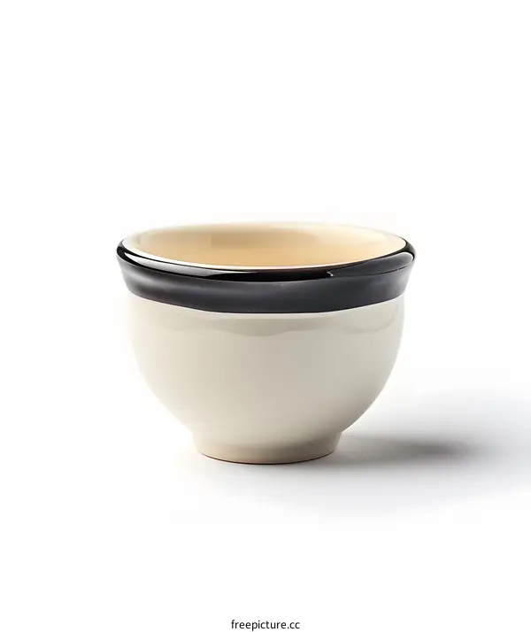 A small white ceramic bowl with black rim