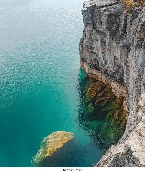 Aerial View of Clear Blue Water and Rock Cliffs
