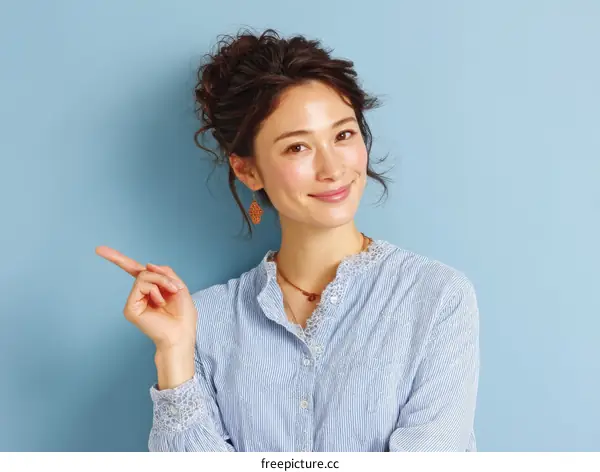 Asian Woman Pointing with Confident Smile