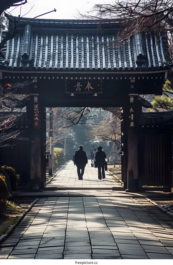 Traditional Japanese Temple Gate with People Walking Through