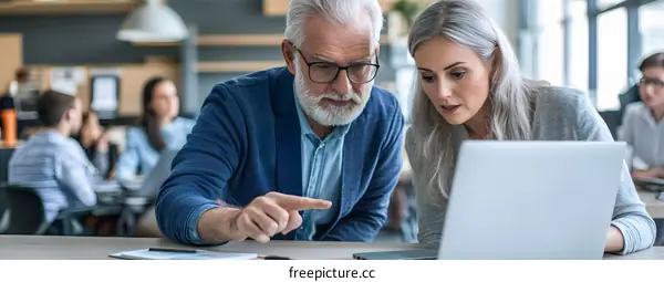 Two Businesspeople Looking at a Laptop
