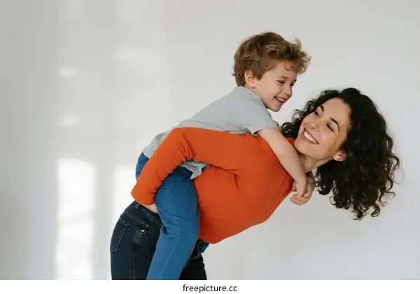 Mother giving her child a piggyback ride showing affection