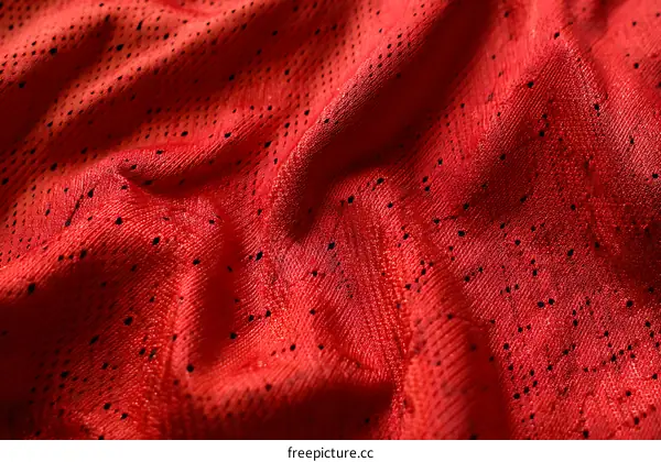 Close-up View of Red Breathable Fabric Texture