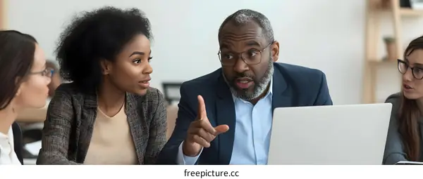 African American Male Businessman Leading Discussion With Colleagues