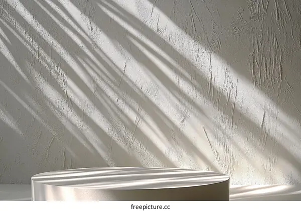 Empty Display Podium Against a Textured Wall with Sunlight Shadows