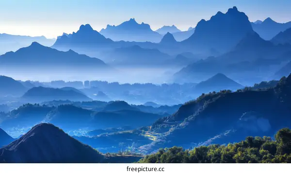 Majestic Mountain Ranges in Misty Blue Light