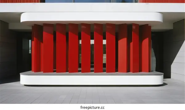 Modern Building Entrance with Red Vertical Elements and White Base