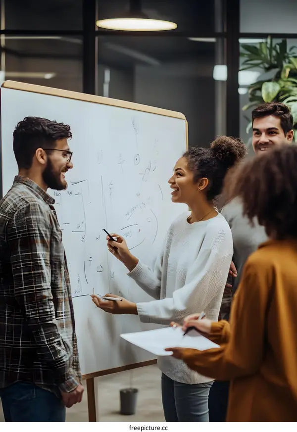 Diverse Team Members Brainstorming Ideas On Whiteboard In Modern Office
