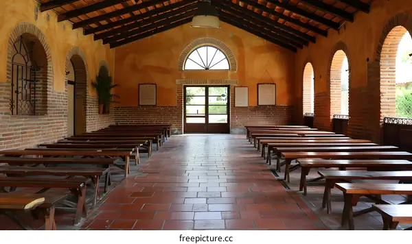 chapel interior with wooden benches and brick walls