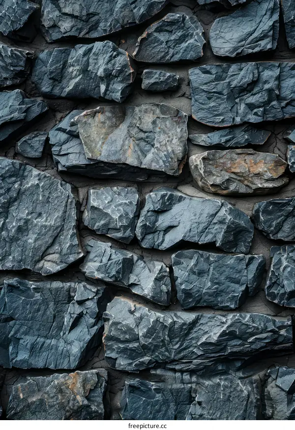 Dark grey rough stone wall texture background