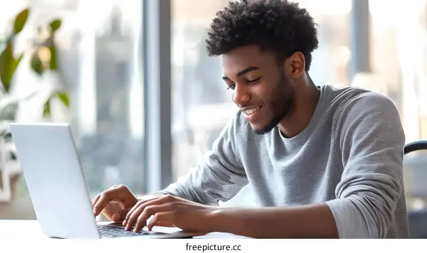 African American Man Working on Laptop at Desk