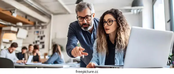 Two Colleagues Working Together on a Project in a Modern Office
