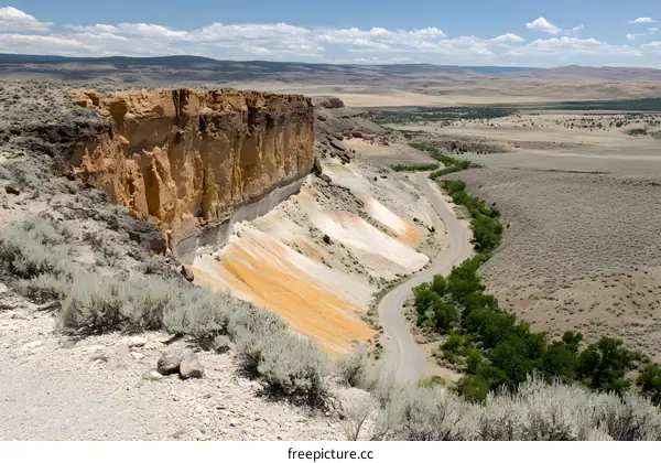 Aerial View of Winding Road Through Colorful Rock Formations