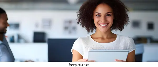 Smiling Woman Holding Tablet in Office