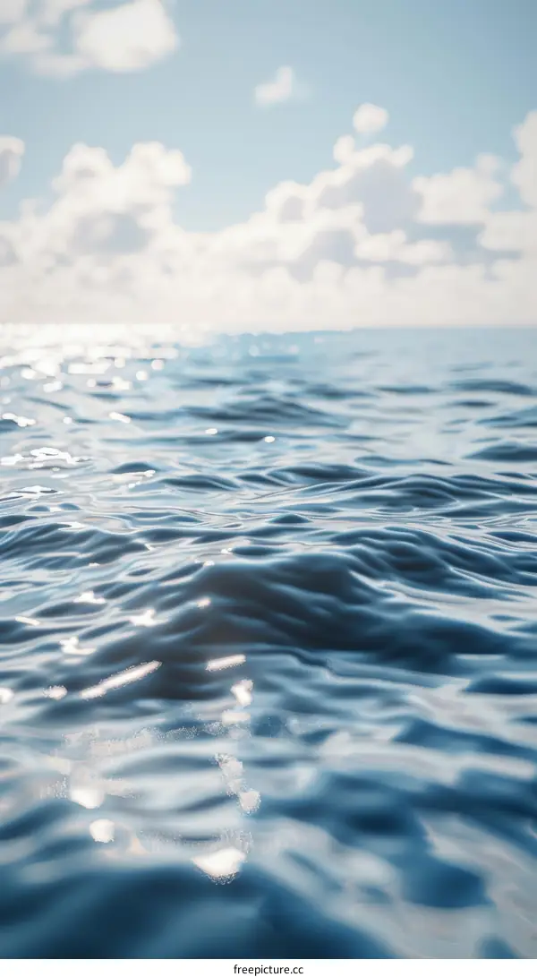 Deep Blue Ocean Surface with Clouds in the Background