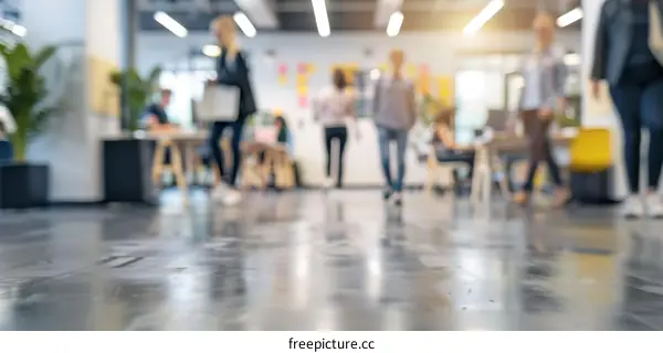 Blurred image of people walking in an office