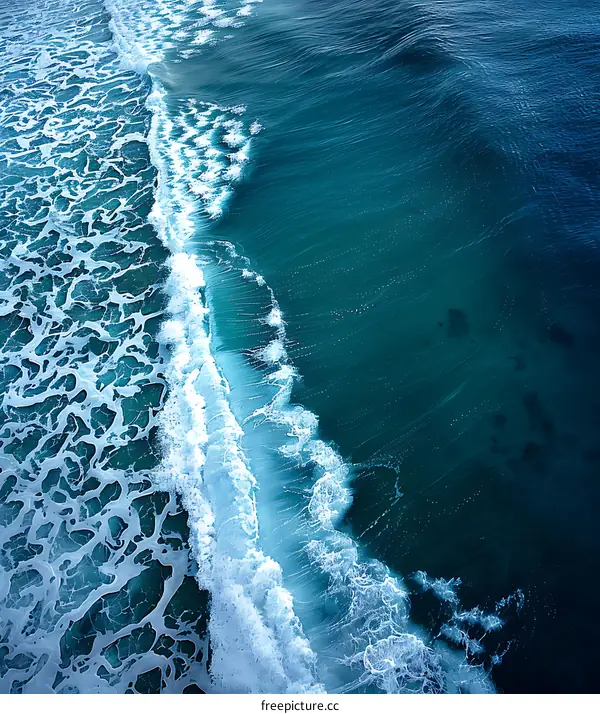 Aerial View of Ocean Waves Breaking on the Shore