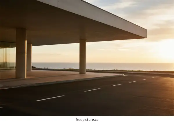 Modern architectural structure with a view of the sea at sunset